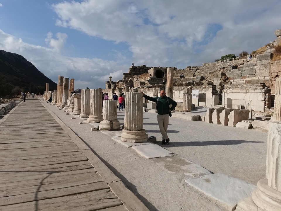 Historical ruins with tourists walking along the path.