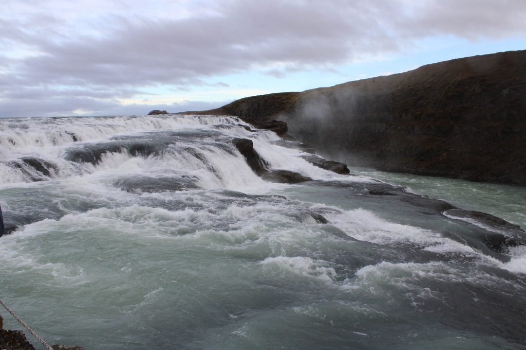 A dynamic waterfall flowing into a river.