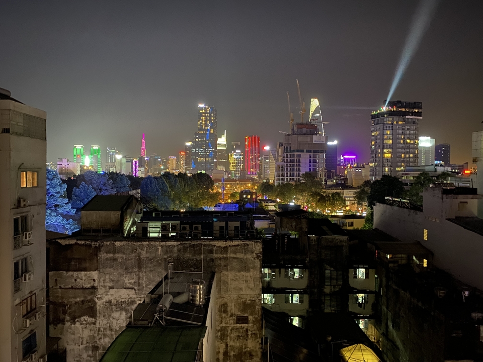 Cityscape at night with illuminated skyscrapers.