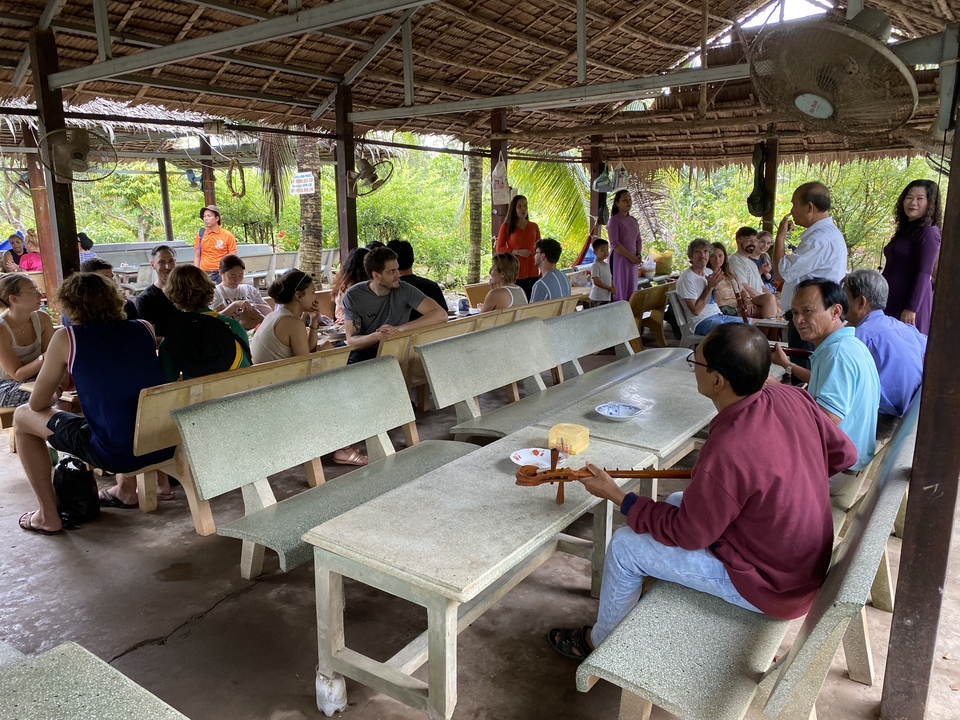 Group of people at an open-air dining area.