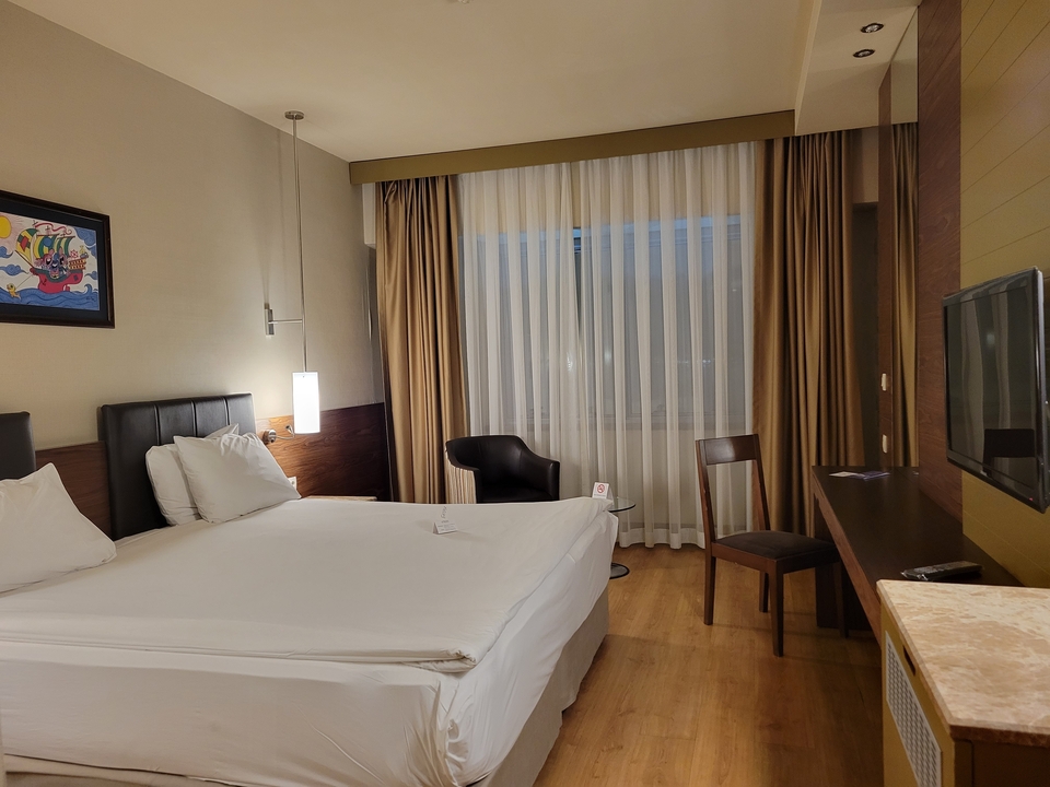 Hotel room with a large bed and modern furnishings.
