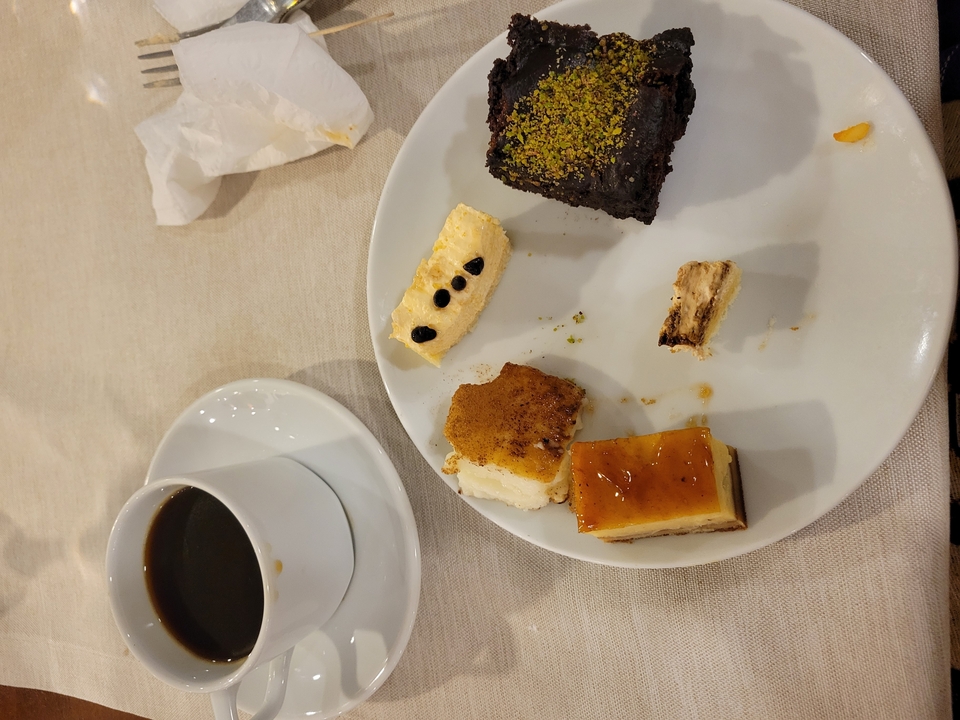 Plate with various desserts and a cup of coffee.