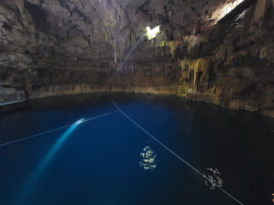 Clear blue water in a cenote cave.