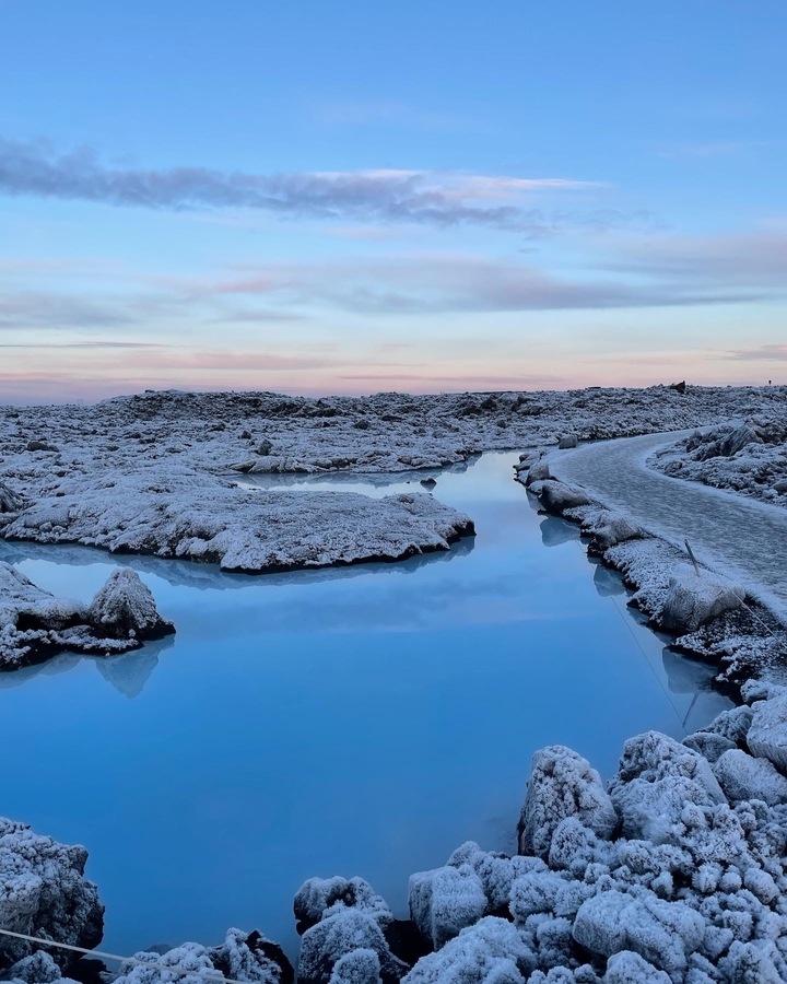 Icy landscape with reflective blue water