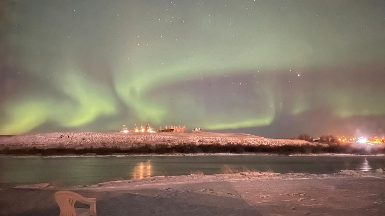 Northern lights over a snowy landscape