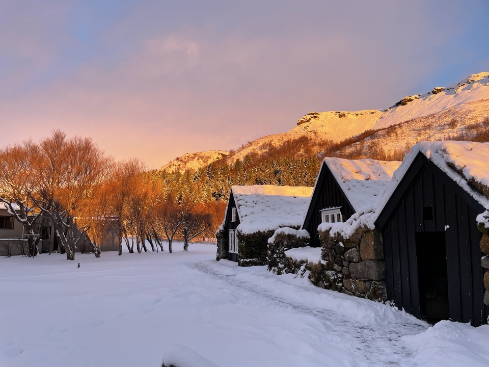 Snowy village with vibrant sunset