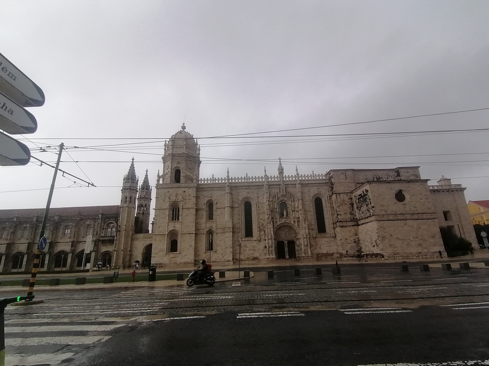 Historic monastery building under a cloudy sky.