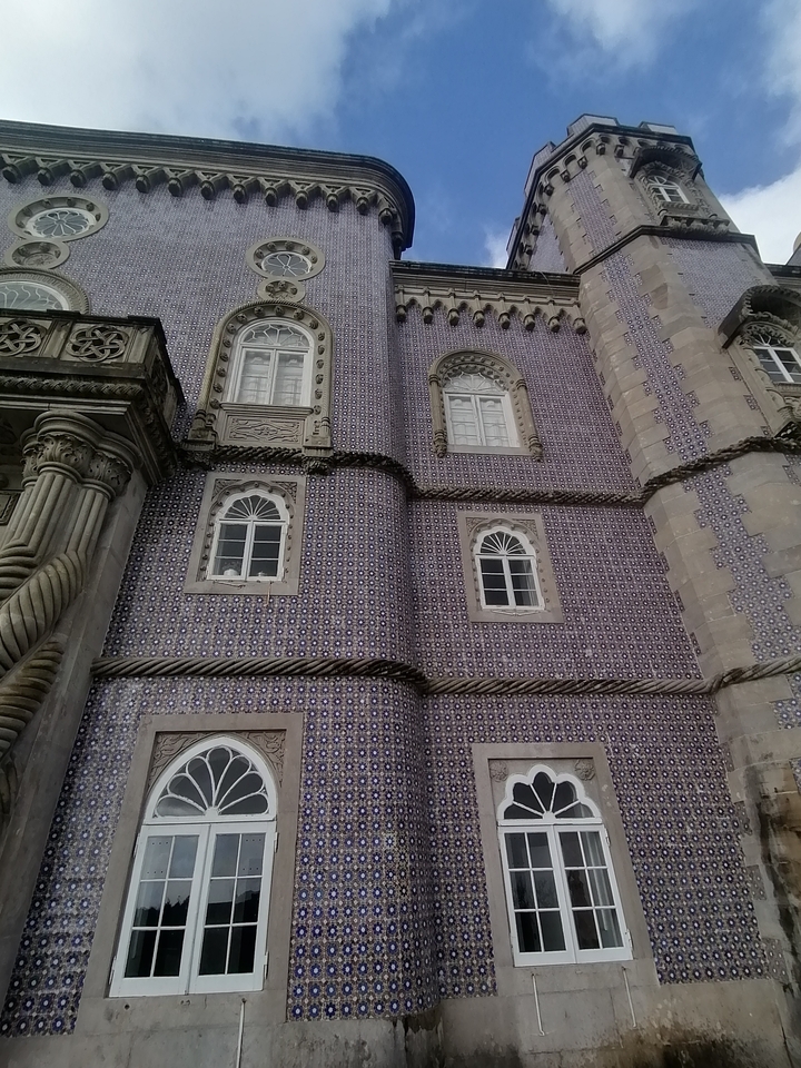 Detailed view of a building facade with colorful tiles.