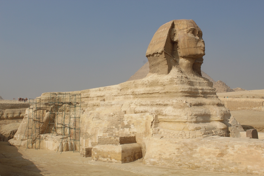 The Great Sphinx of Giza with pyramids in the background.
