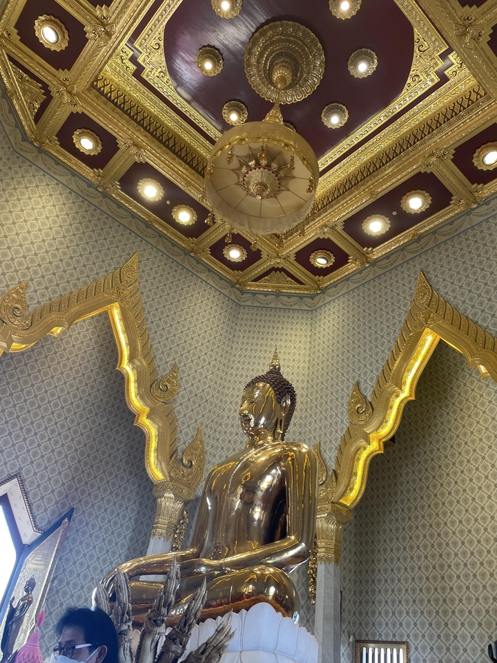 Golden statue within a decorated indoor setting.