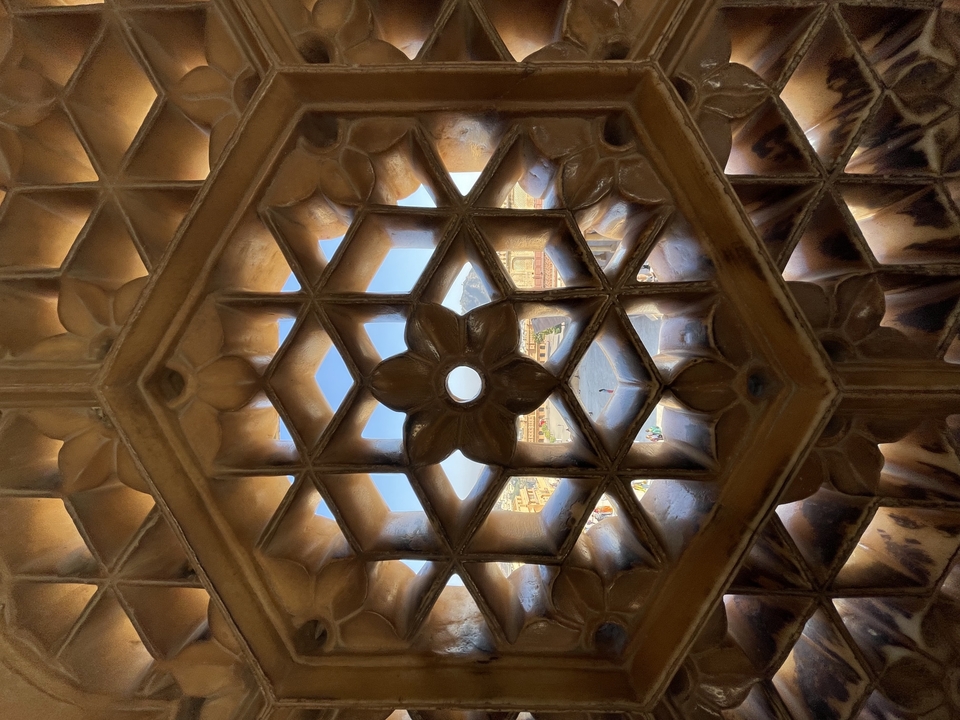 Decorative carved stone window framing the view outside.