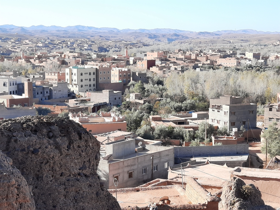 View of a town with buildings and barren landscape.