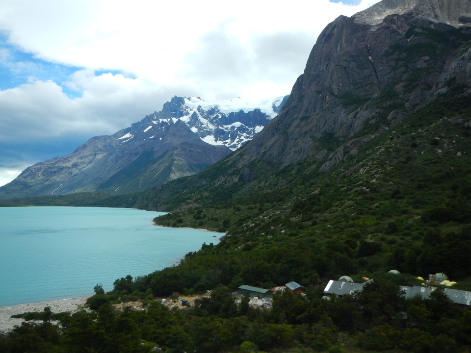 Scenic mountain range next to a blue glacial lake.
