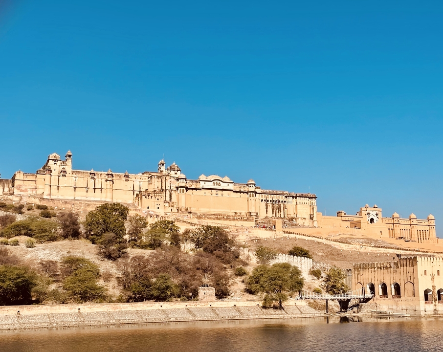 Large historic fortress on a hill under a blue sky.