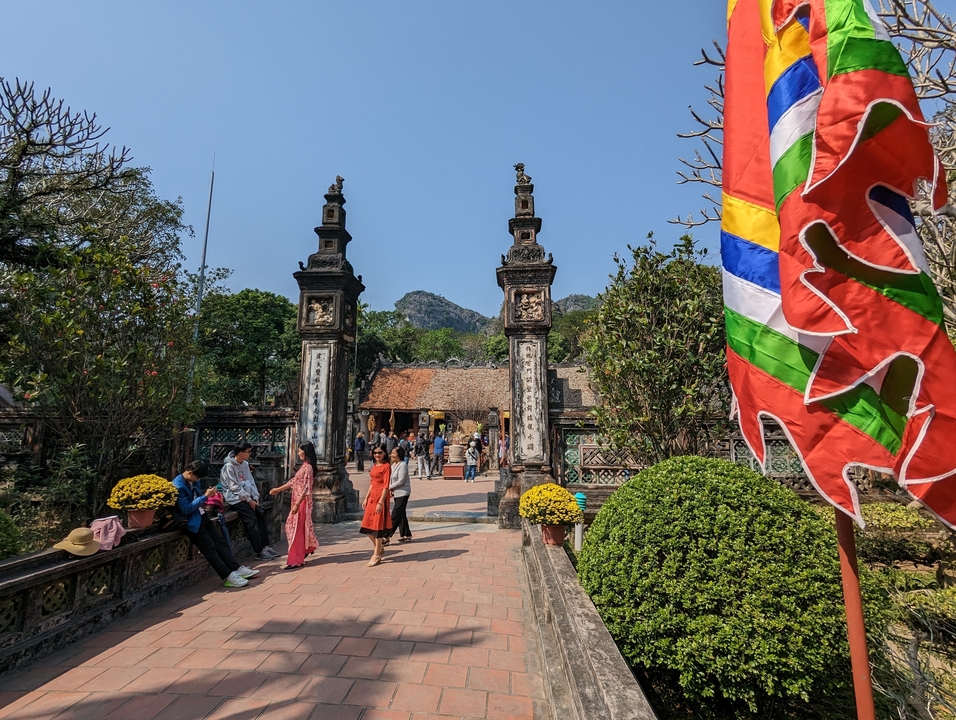 Site historique avec des groupes de touristes et une architecture traditionnelle.