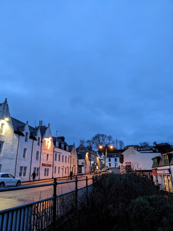 Evening view of a small town with streetlights on.