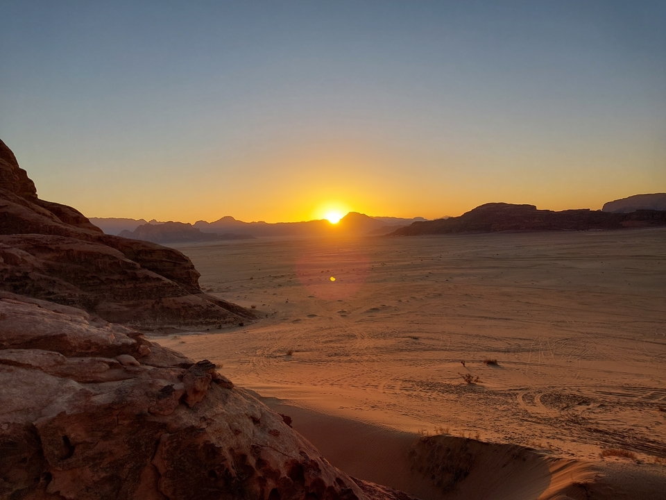 Sunset over a rocky desert landscape.