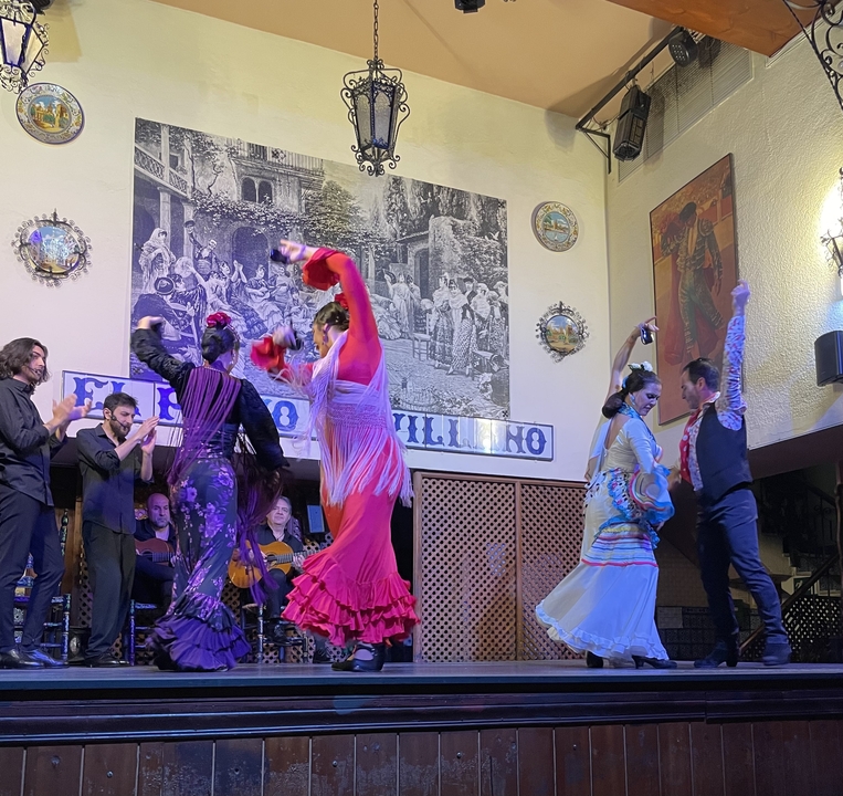 Group of people dancing in traditional attire.