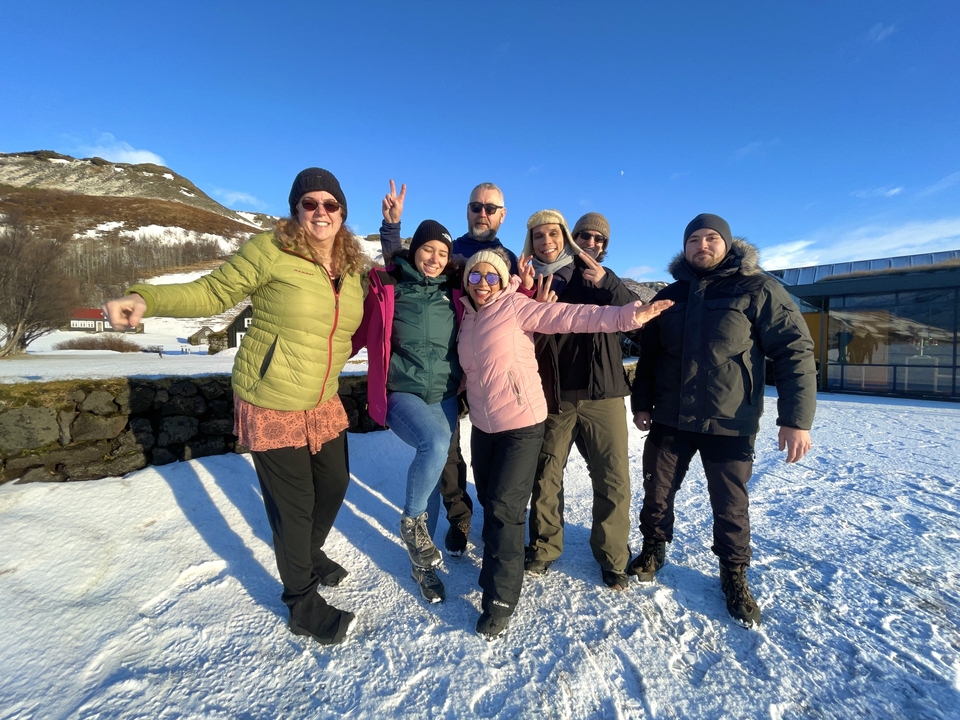 Group of people posing on a snowy landscape.
