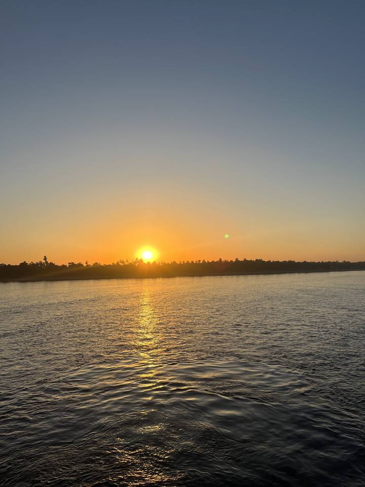 Sunset view over a river with reflecting water.