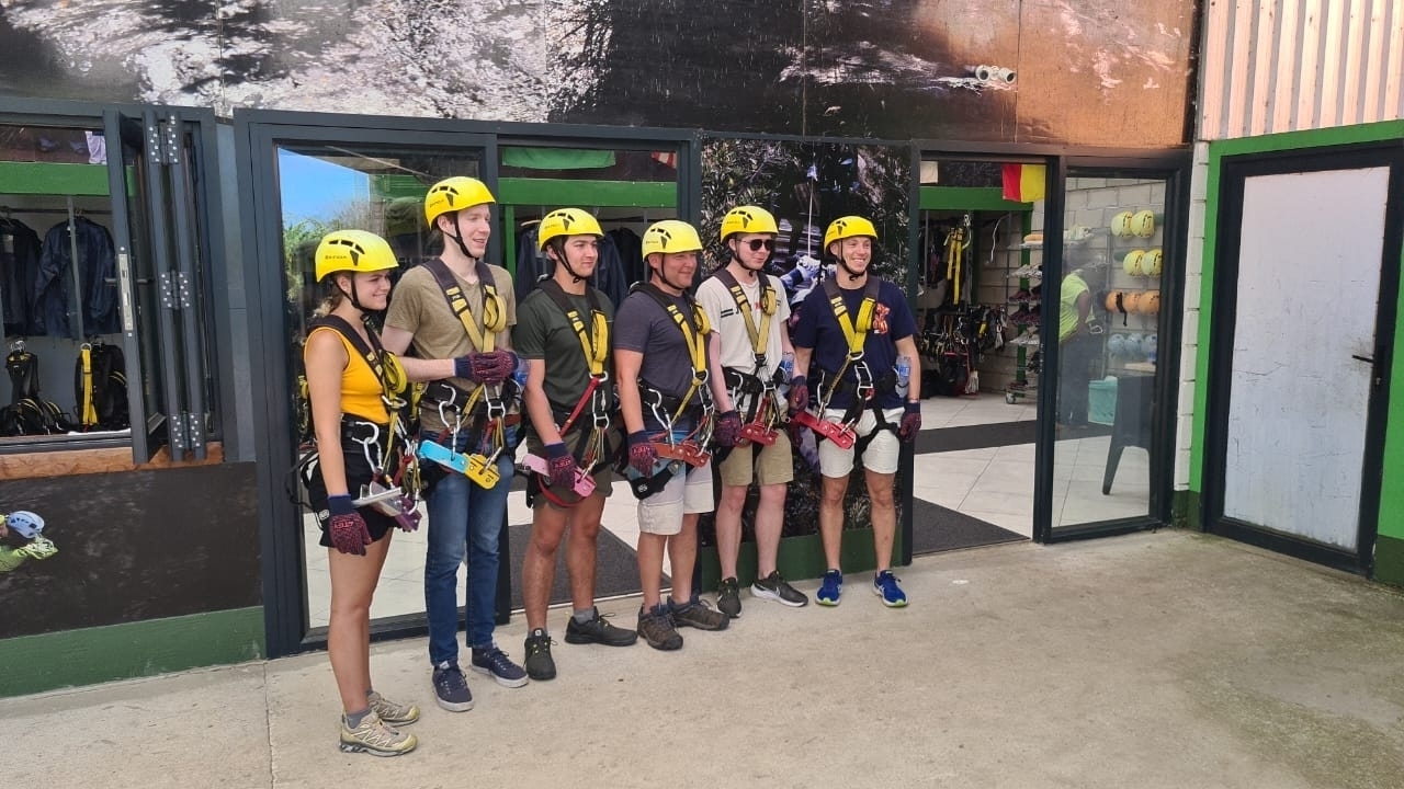 Group of people equipped with harnesses posing for a photo.