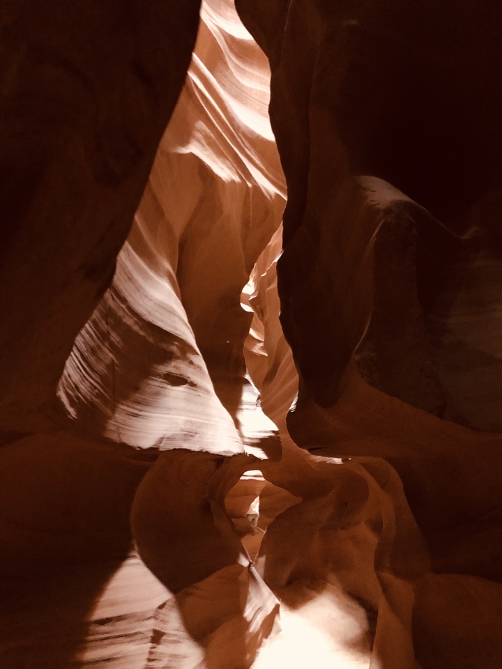 Antelope Canyon with sunlight filtering through the rock formations.
