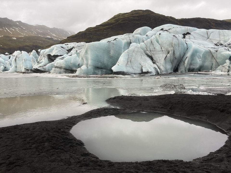 Majestic glacier with blue ice and surrounding water.