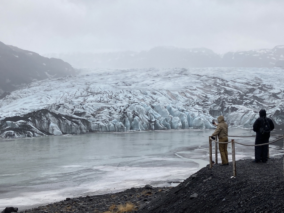 People viewing a glacier landscape.