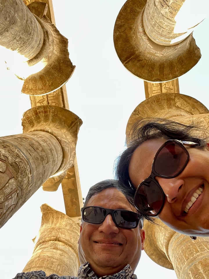 People taking a selfie with Egyptian columns in the background.