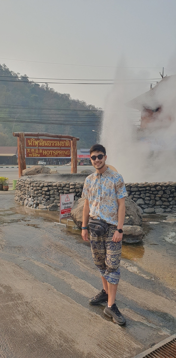 Person standing in front of a natural hot spring.