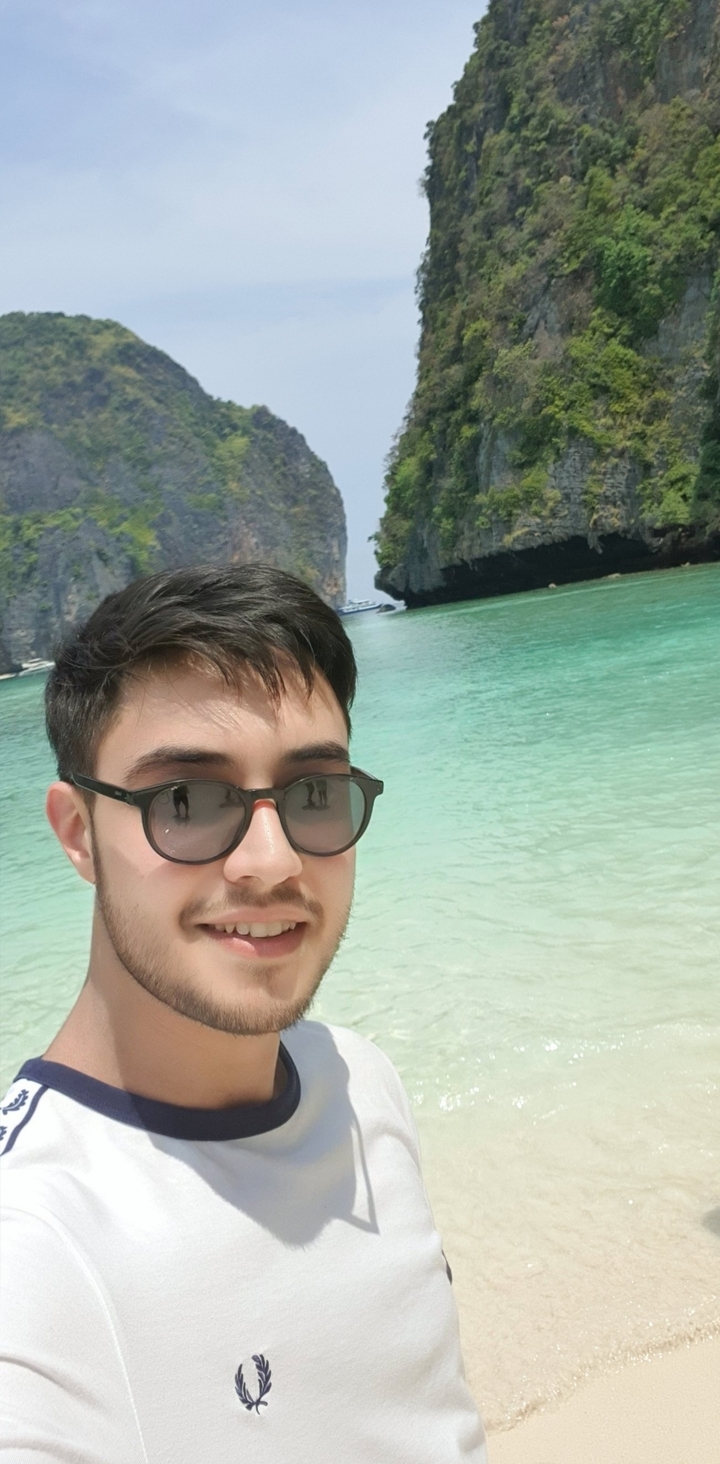 A person enjoying a beach with turquoise water.