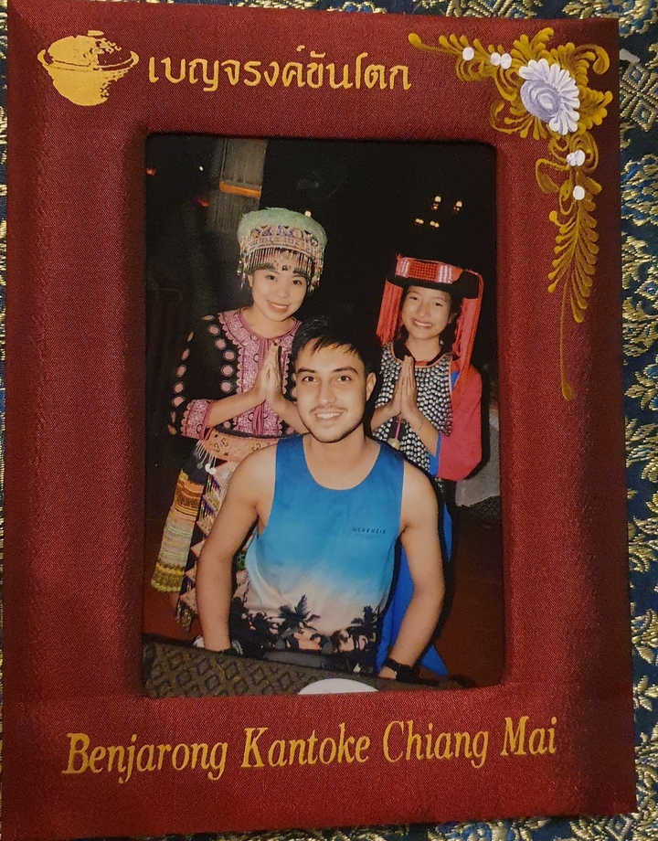 Three people in traditional clothing posing for a photo.