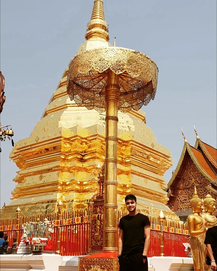 Golden stupa of a temple with intricate details.