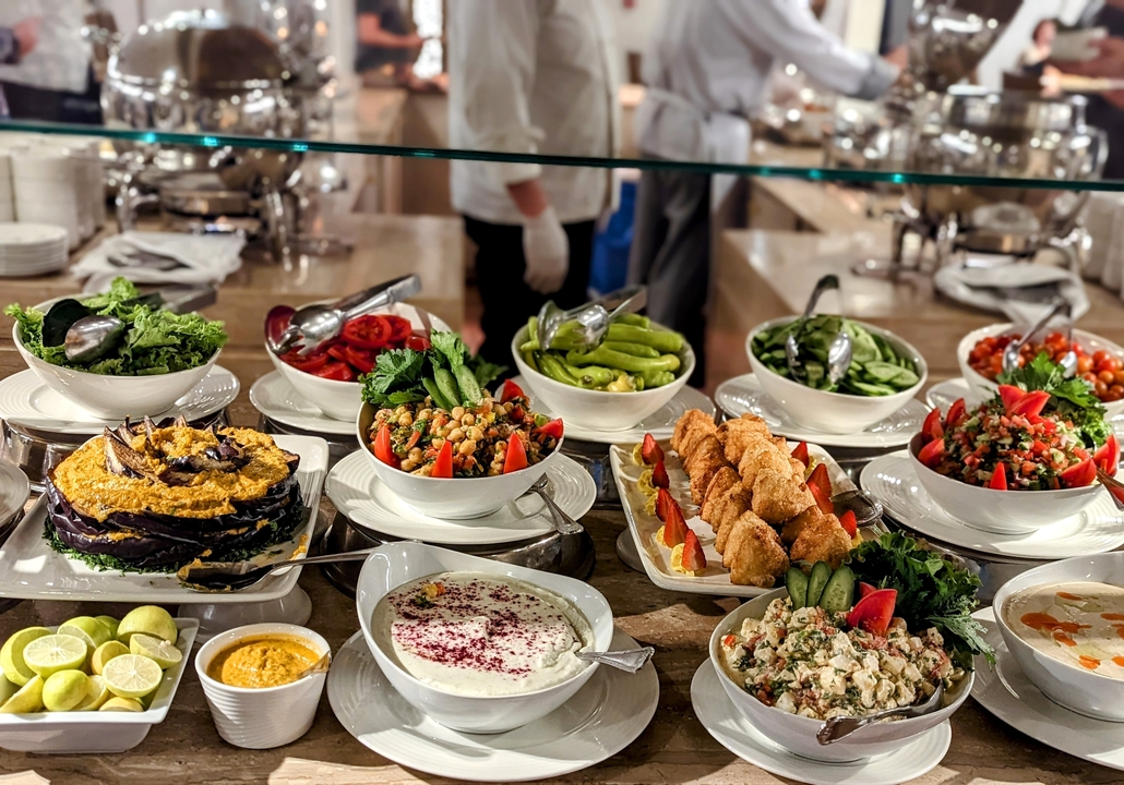 Buffet display with various salads and dishes.
