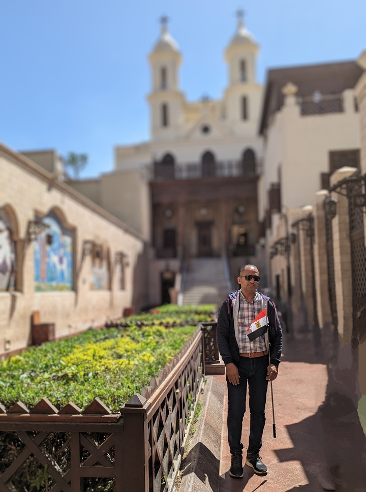 Tourist holding a flag outside a historic building.