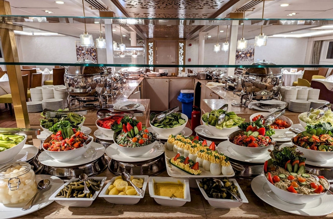 Buffet spread with various dishes and salads.