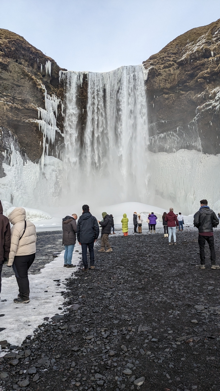 Tourists at a frozen waterfall
