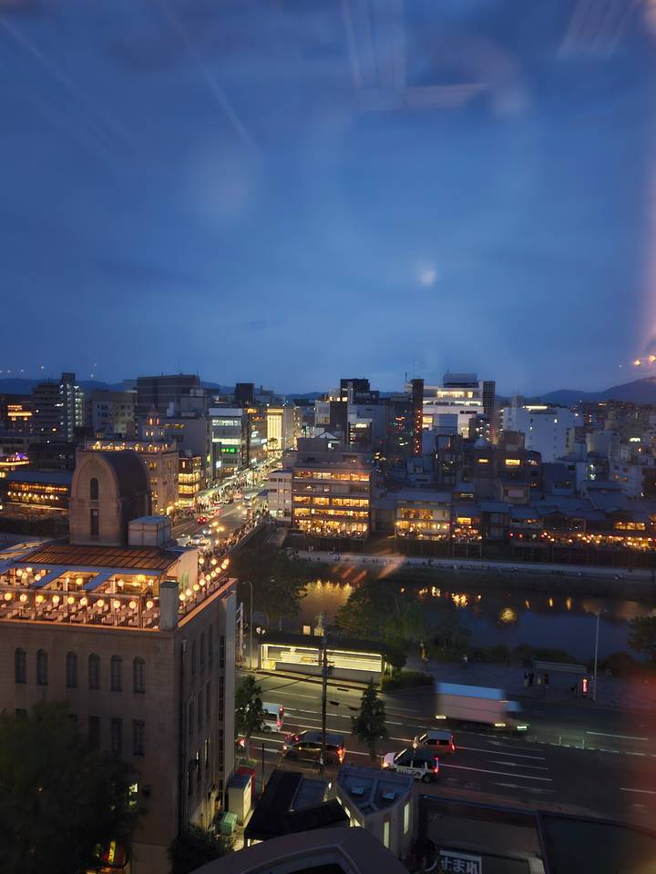 City skyline at dusk with illuminated buildings.