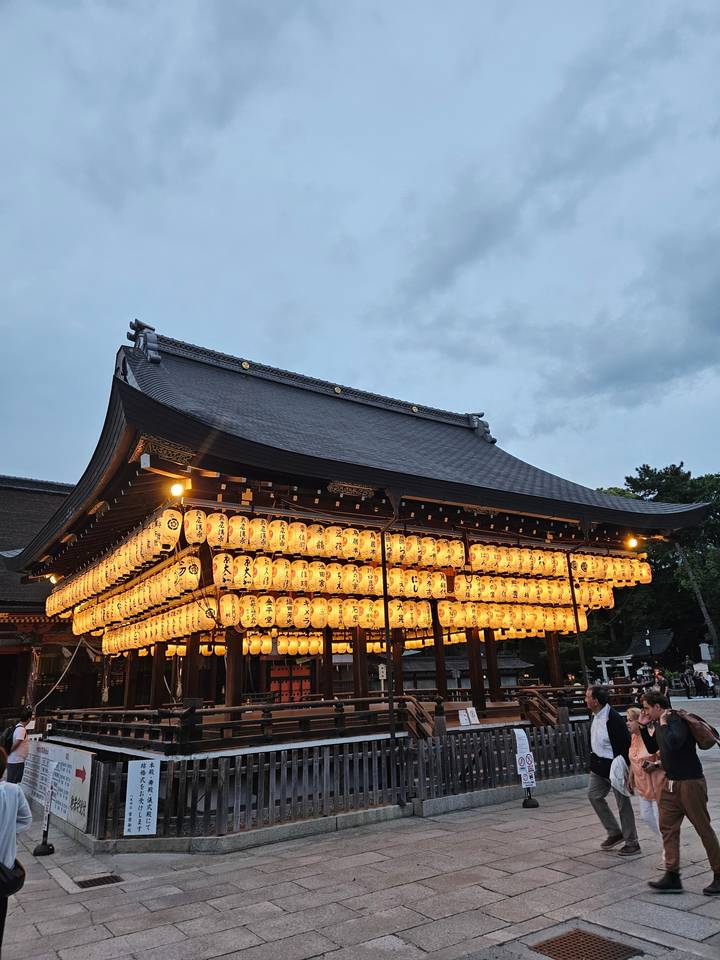Japanese shrine with glowing lanterns.