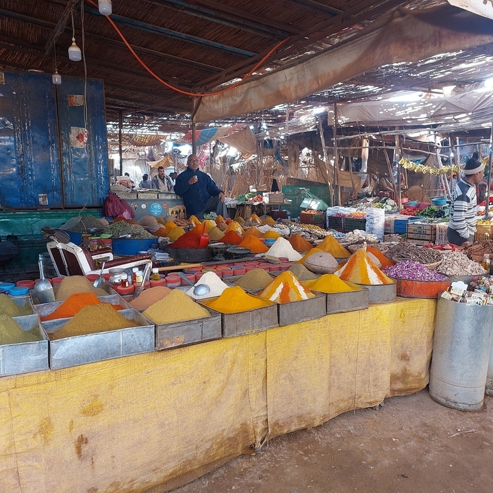 Colorful spice market stall with various spices.