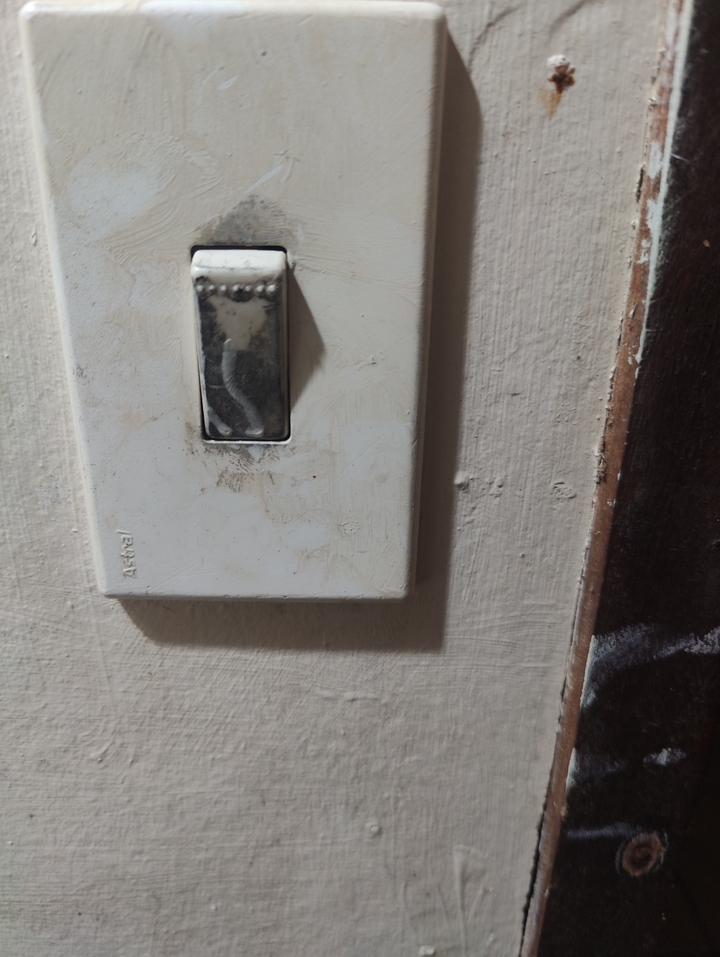 Close-up of a light switch on a wall.