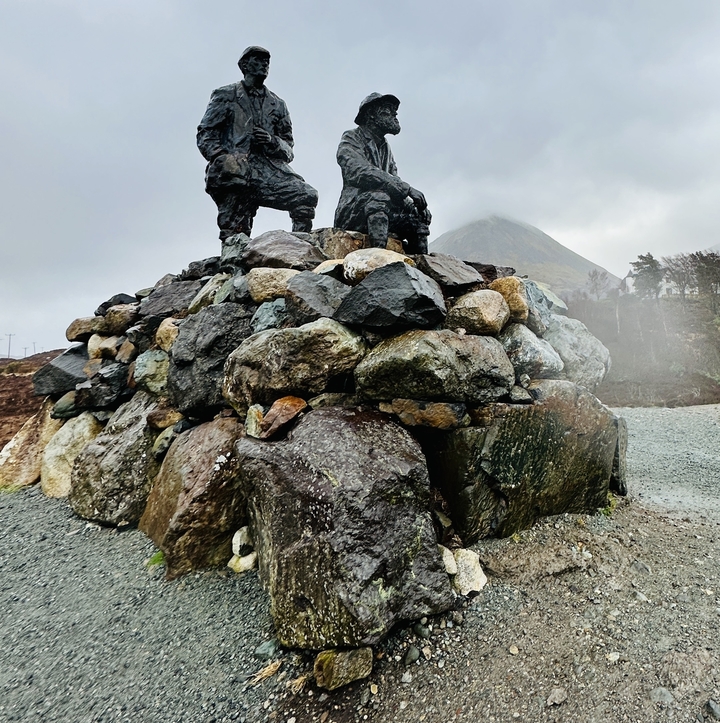 Mountainous landscape with a mound of stones and a monument.