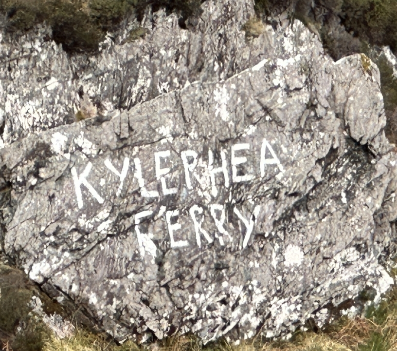 Close-up of a rock with the words 'KYLERHEA FERRY' painted on it.