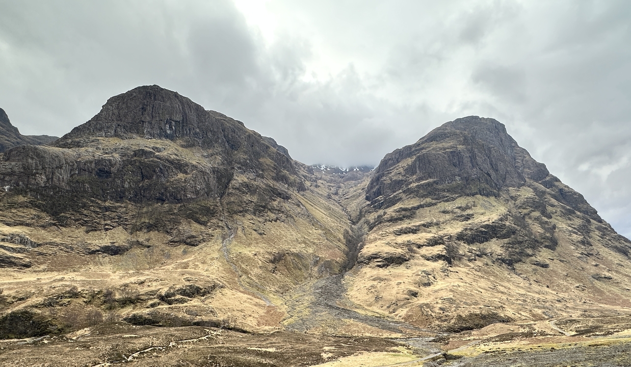 Rugged mountains under a cloudy sky.