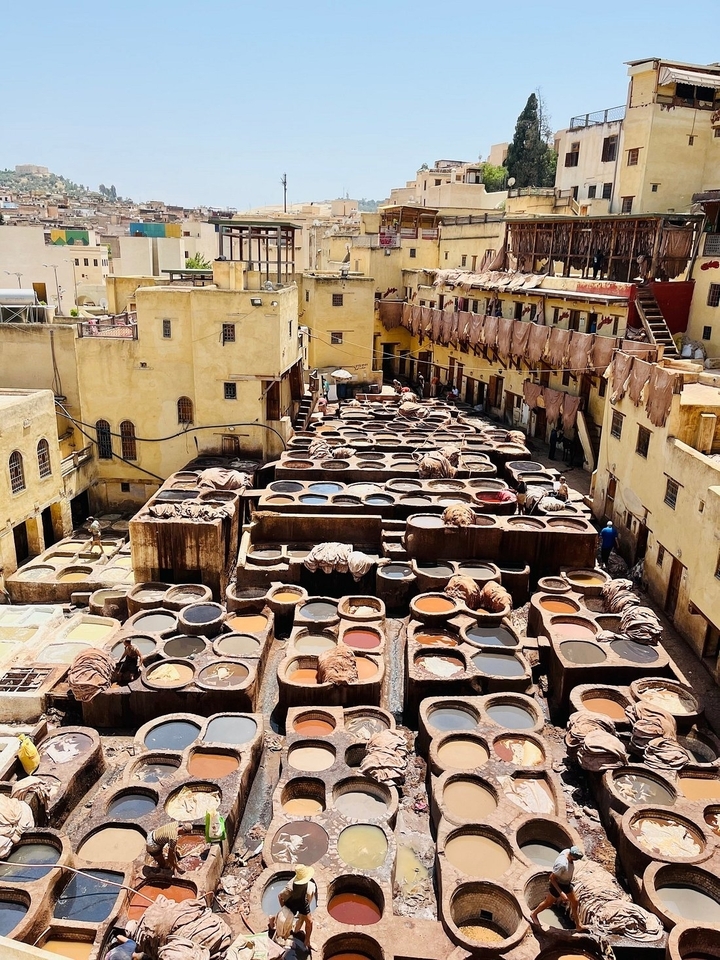 Traditional tannery with multiple dyeing vats.