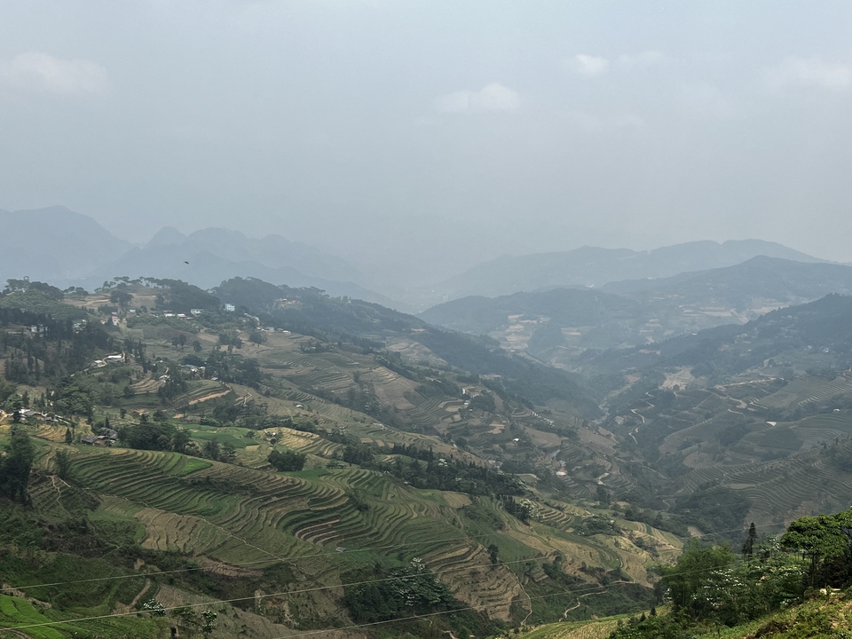 Wide view of terraced valleys and mountains.