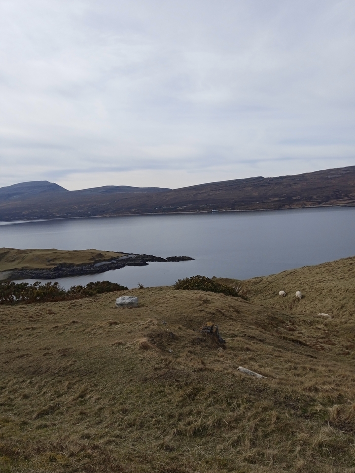 Mountain lake view with rocky hills.