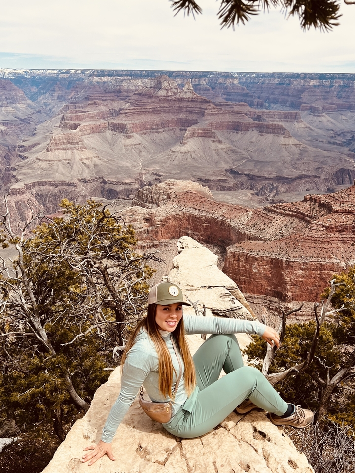 Person posing with Grand Canyon view.
