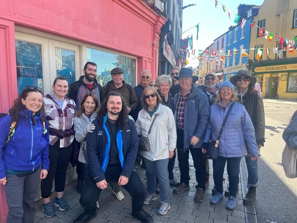 Group of people standing in a colorful street.
