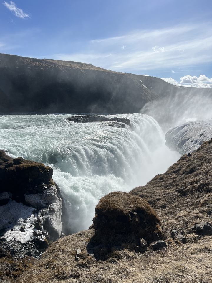 Powerful waterfall with mist and rocks.